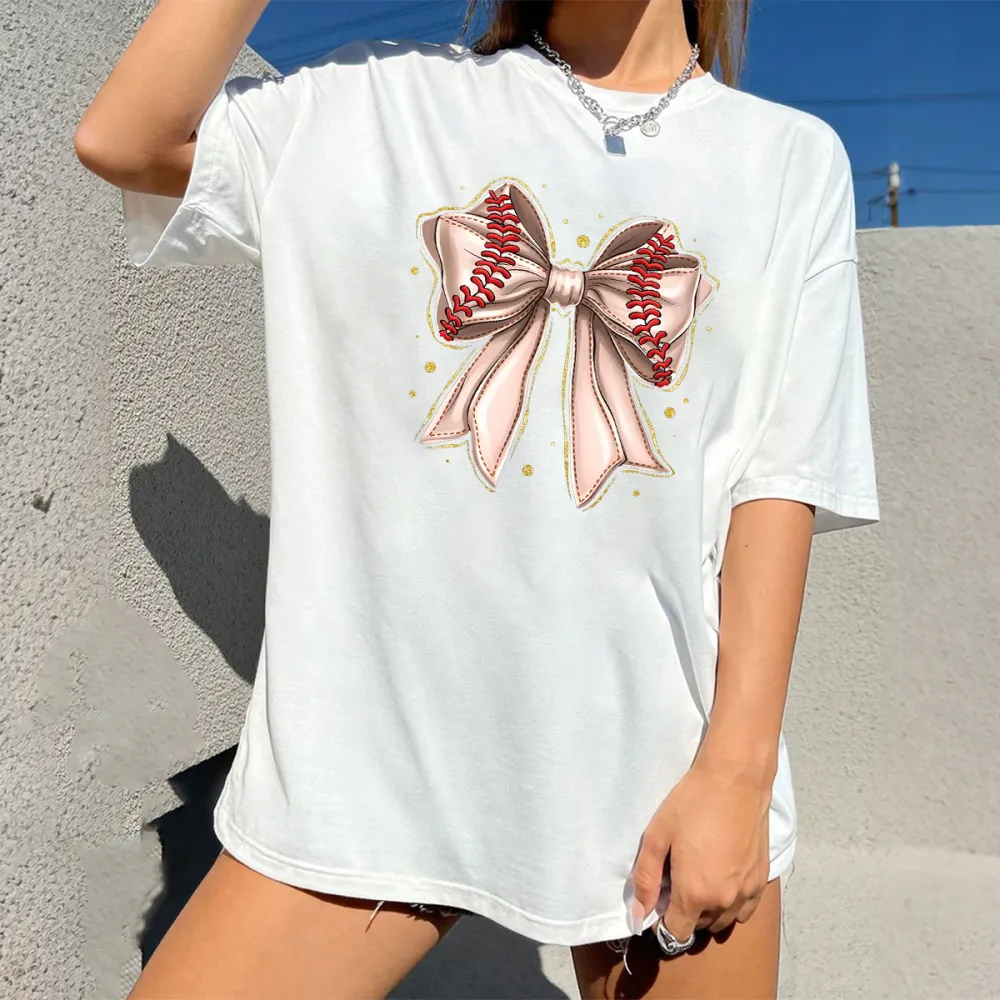 A Casual T-Shirt With A Light Pink Bow And Red Baseball Stitching On The Two Straps.
