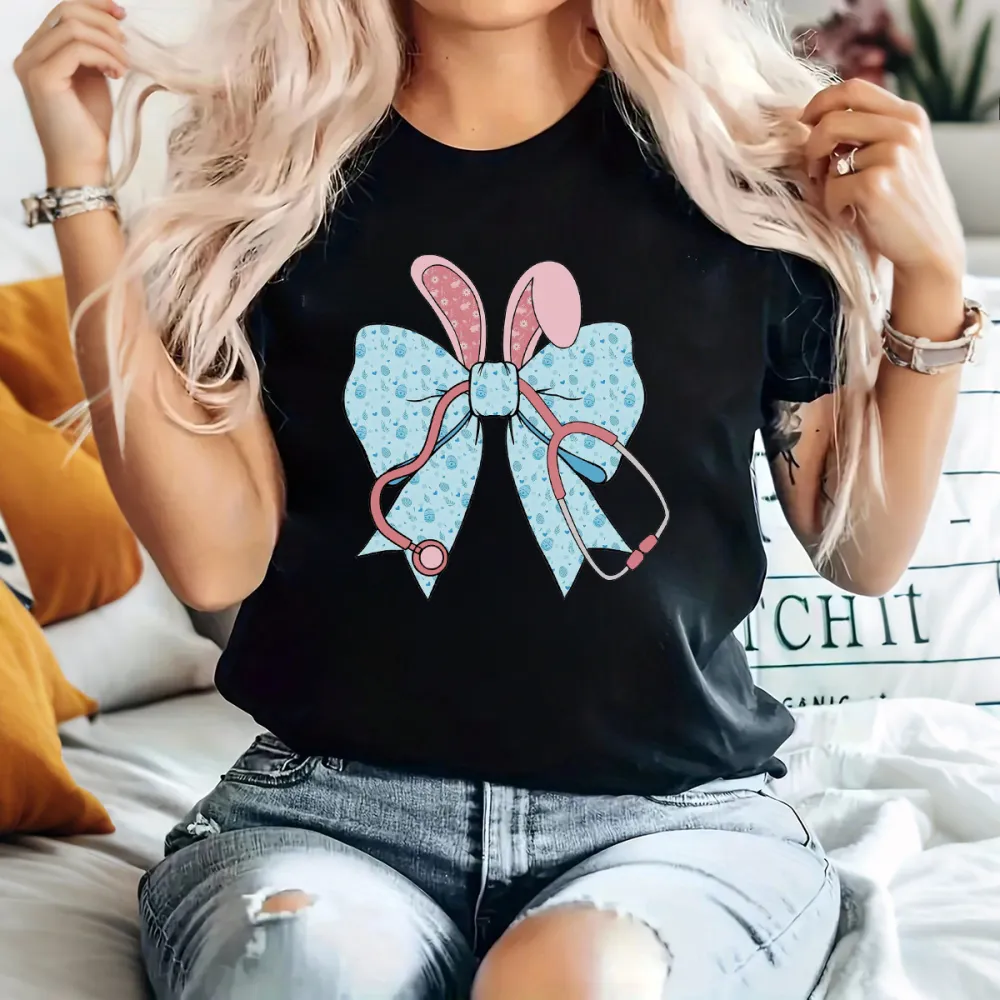 A Cartoon Rabbit Ear Element Bow Pattern, The Bow Has Blue Dots, The Rabbit Ears Are Pink With White Dots And A Pink Stethoscope Pattern, Casual T-Shirt