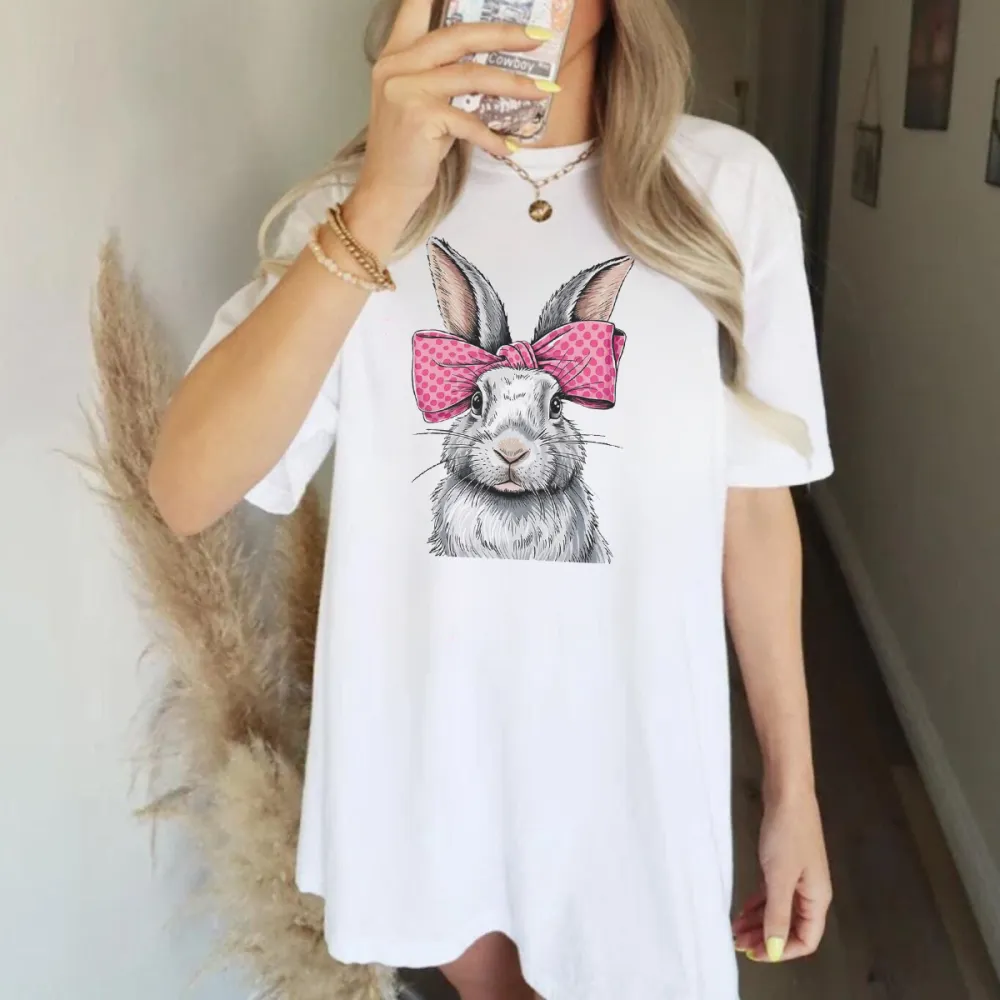 A Cartoon Rabbit With Ears Erected, Wearing A Pink Bow With White Polka Dots, Casual T-Shirt