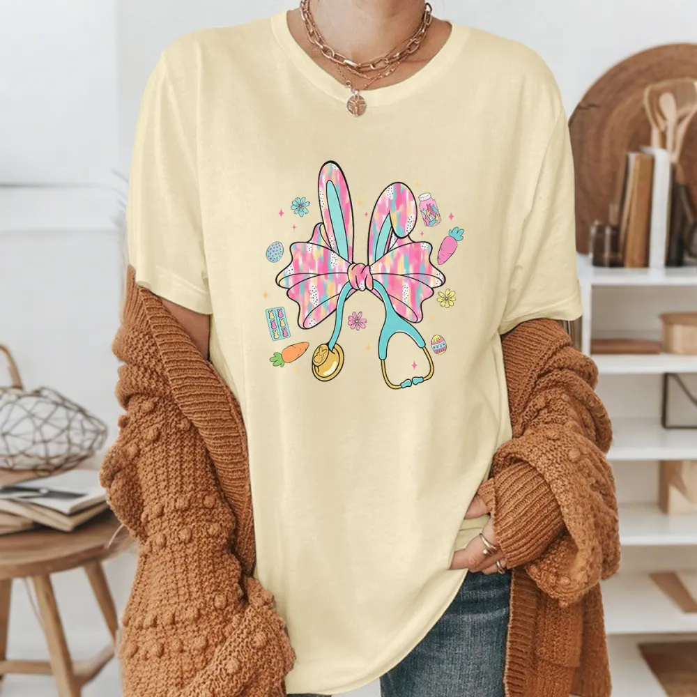 A Big Colorful Bow, Rabbit Ears, And Surrounded By Carrots, Easter Eggs, And Stethoscope Patterns. The Overall Style Is Lively And Casual T-Shirt.