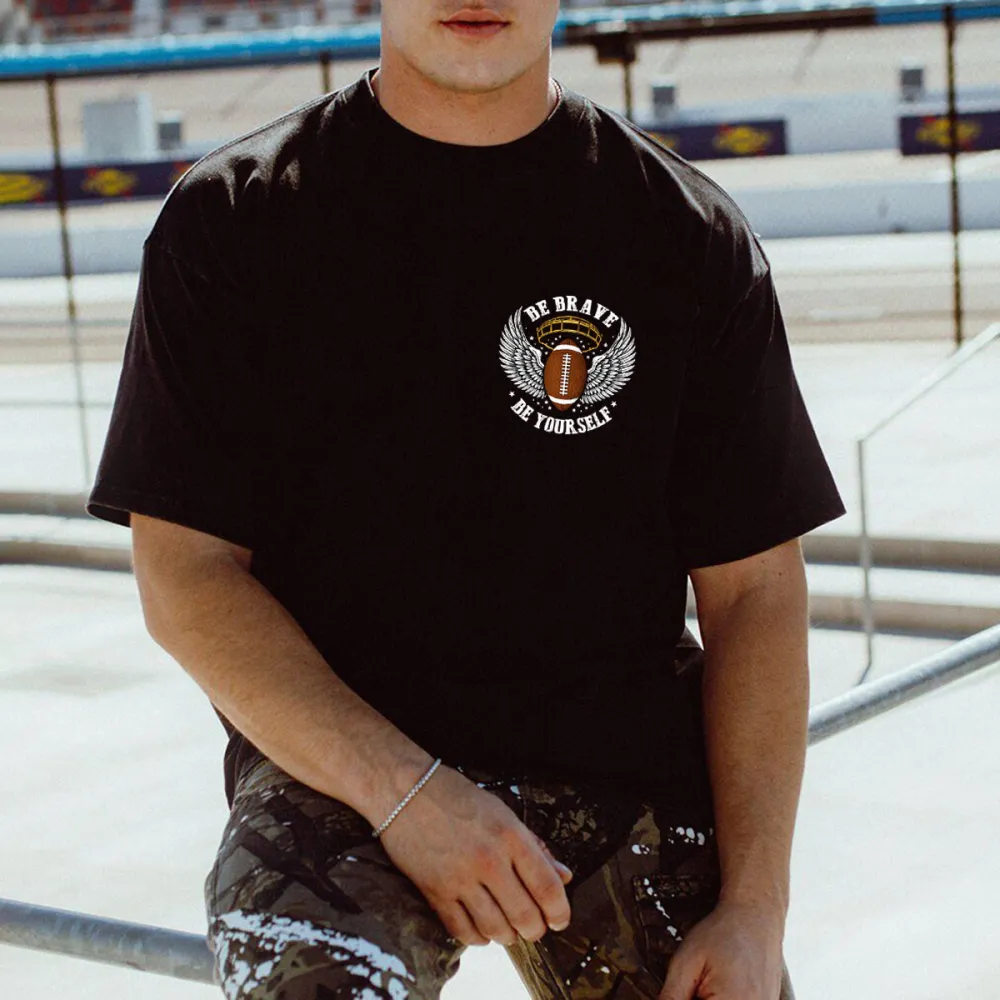 There Are Wings On Both Sides Of The Football, The Outline Of A Football Helmet, And The Words 