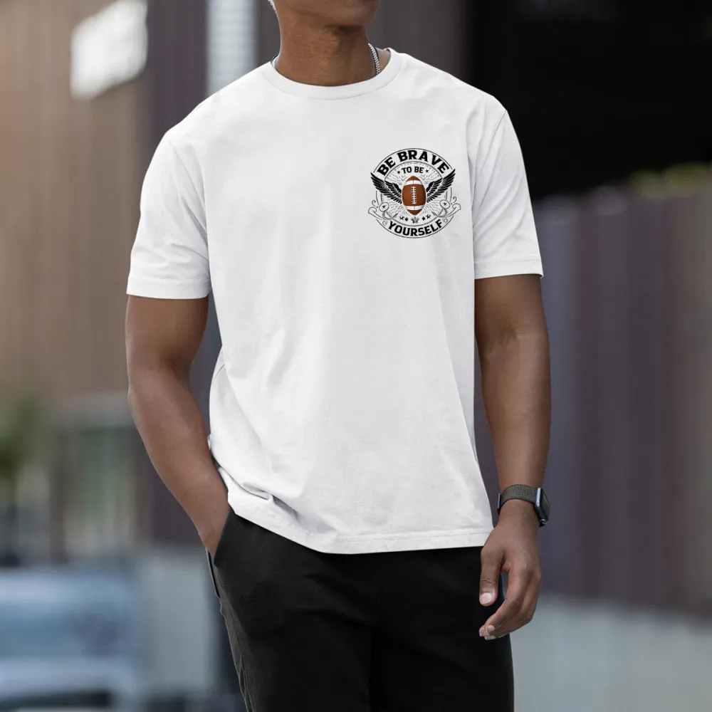 This Is A Graphic T-Shirt With Sports And Inspirational Elements. There Is A Rugby Ball In The Middle And Wings On Both Sides. The Words 