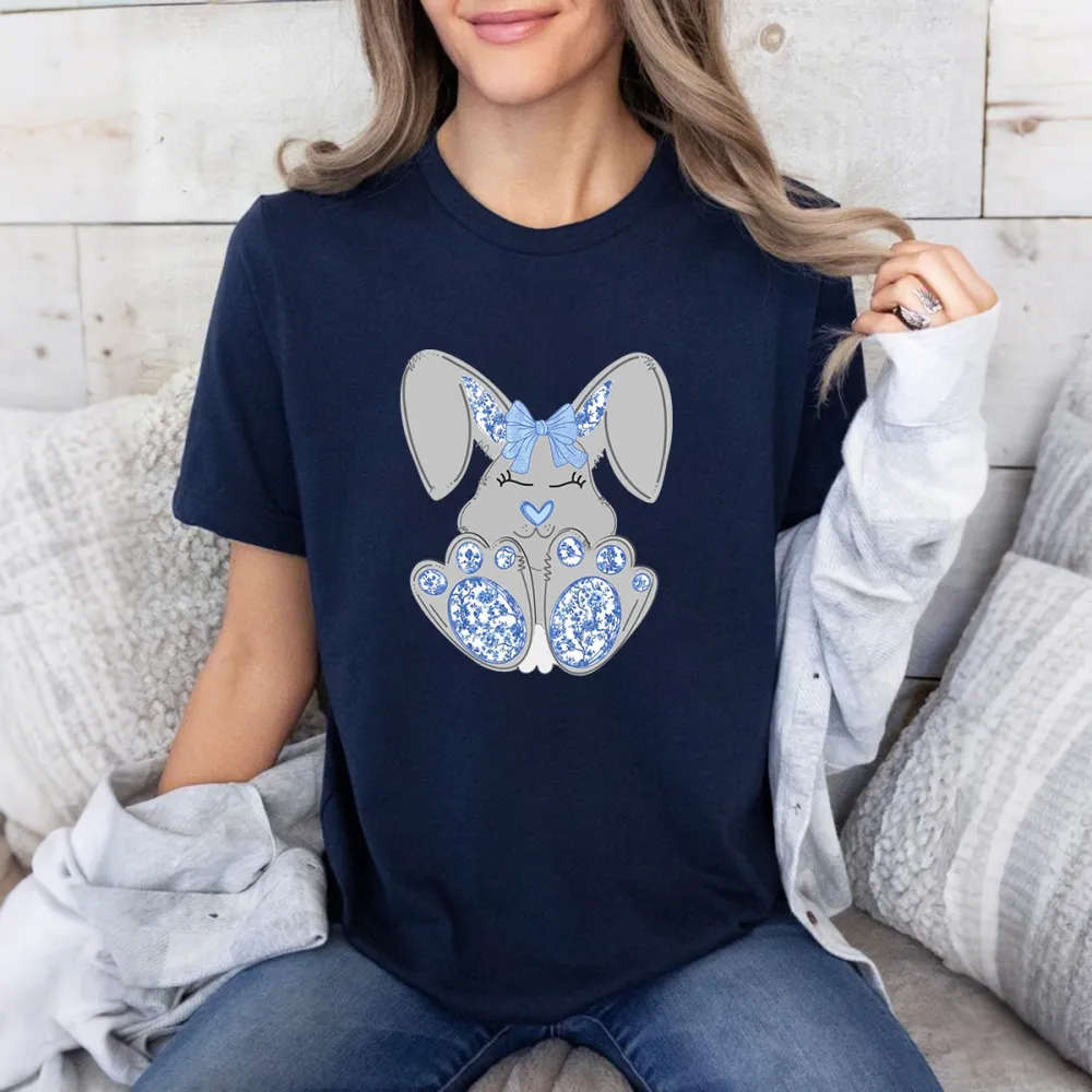 A Cartoon Gray-Blue Rabbit, The Inside Of The Ears, The Bow And The Heart Are Blue, And The Soles Of The Feet Have Blue And White Patterns, Cute, Casual T-Shirt