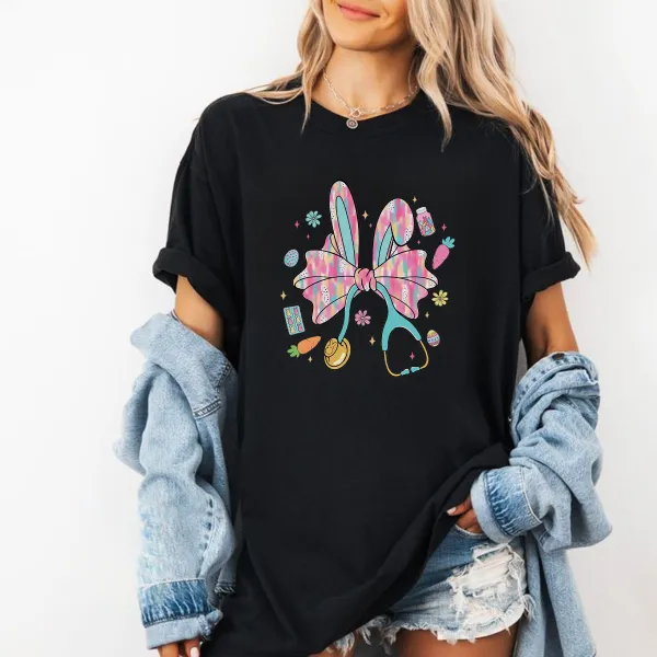 A Big Colorful Bow, Rabbit Ears, And Surrounded By Carrots, Easter Eggs, And Stethoscope Patterns. The Overall Style Is Lively And Casual T-Shirt.