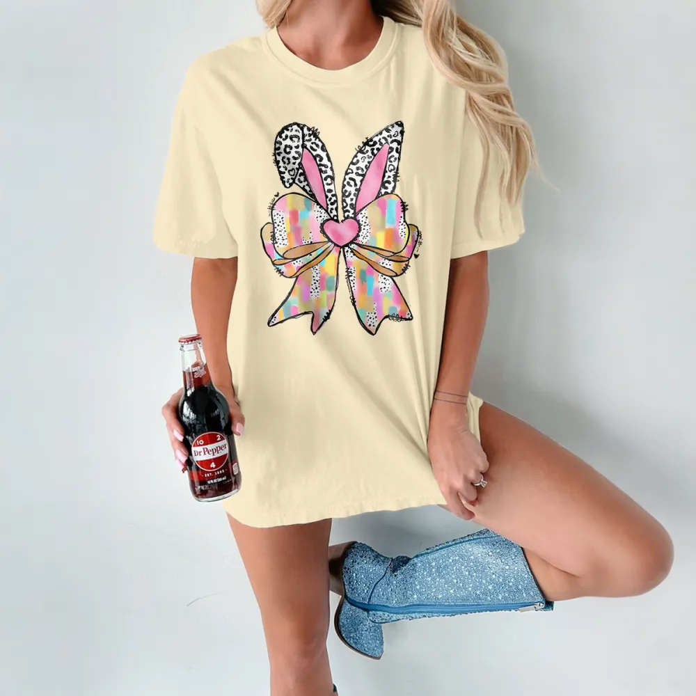 A Colorful Plaid Bow In The Shape Of Rabbit Ears, With Leopard Print Decorations And A Pink Heart Pattern On The Ears, And A Casual T-Shirt.