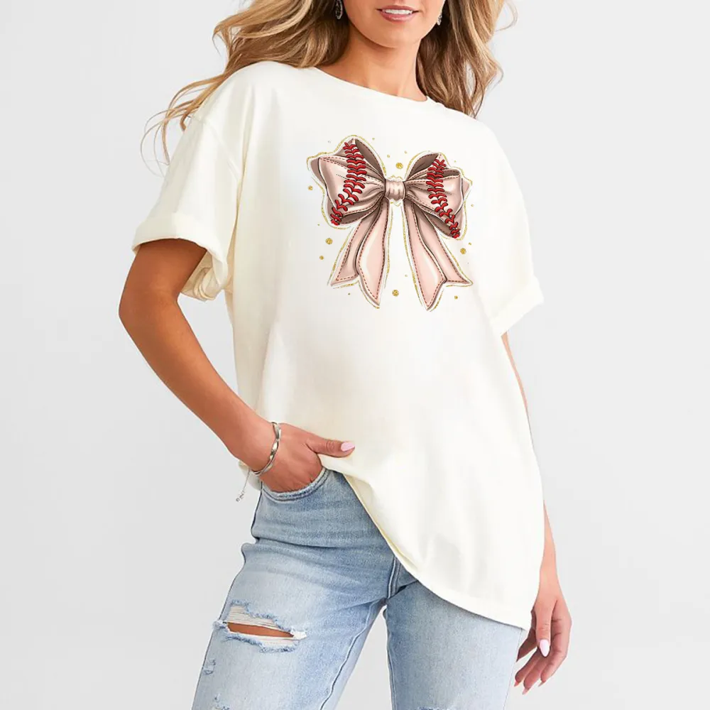 A Casual T-Shirt With A Light Pink Bow And Red Baseball Stitching On The Two Straps.