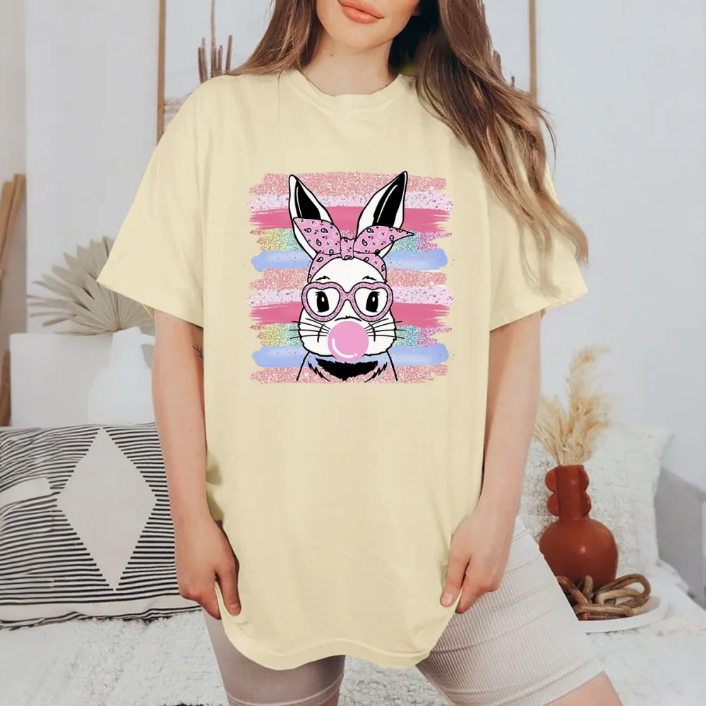 The Pattern Of A Rabbit Wearing A Pink Bow And Glasses, Blowing Pink Bubble Gum In His Mouth, With Colorful Striped Brushstrokes In The Background, Playful And Lively Style, Casual T-Shirt.