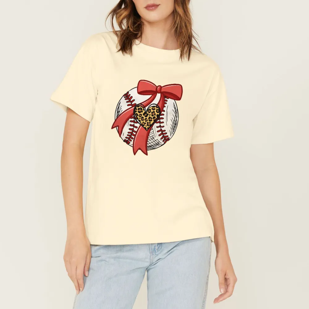 A Pattern Combining A Stitched Baseball, A Red Bow And A Leopard Print Heart. There Is Also A Leopard Print Heart Pattern On The Ball, A Casual T-Shirt.