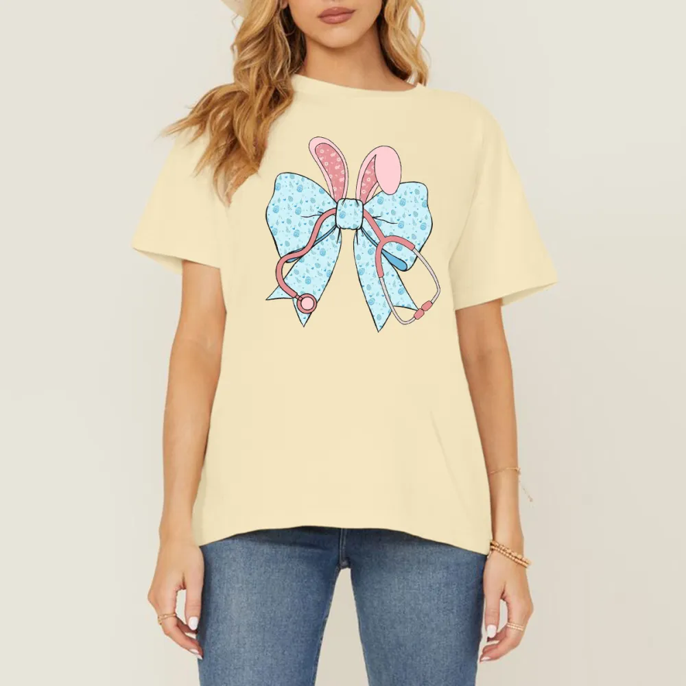 A Cartoon Rabbit Ear Element Bow Pattern, The Bow Has Blue Dots, The Rabbit Ears Are Pink With White Dots And A Pink Stethoscope Pattern, Casual T-Shirt
