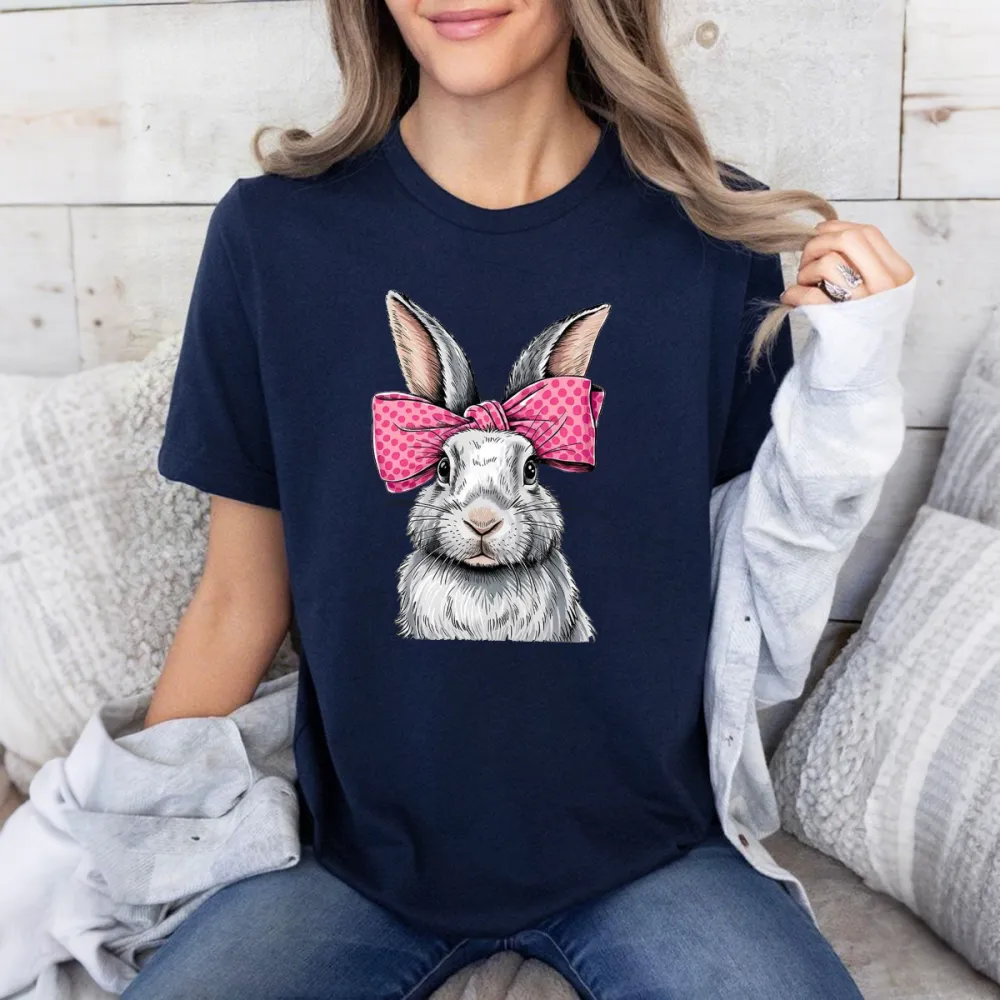 A Cartoon Rabbit With Ears Erected, Wearing A Pink Bow With White Polka Dots, Casual T-Shirt