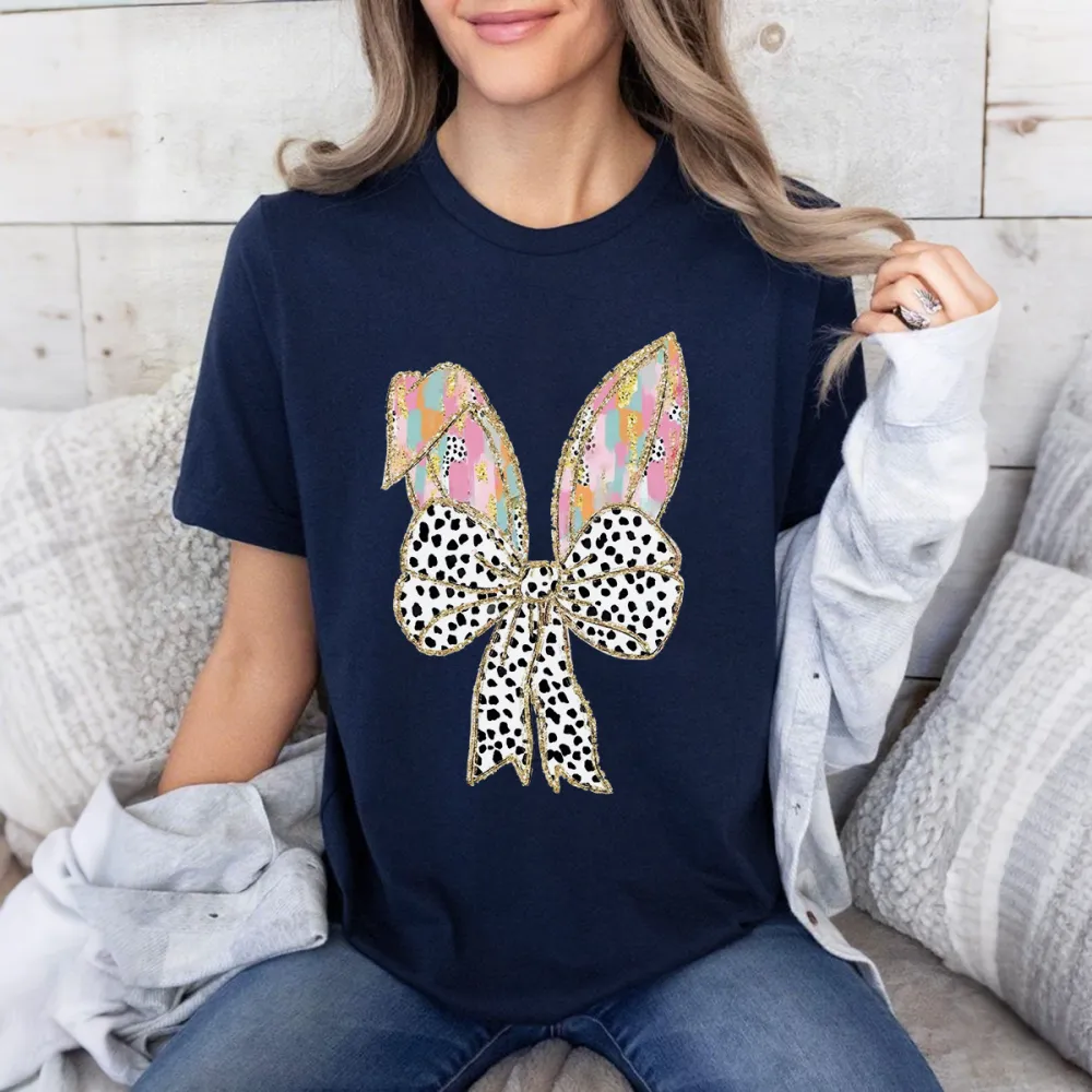 There Are Colorful Geometric Patterns On The Cartoon Rabbit Ears, With Gold Decorations On The Edges And A Big Bow With Black And White Spots, Which Is Lively And Cute, And A Casual T-Shirt.