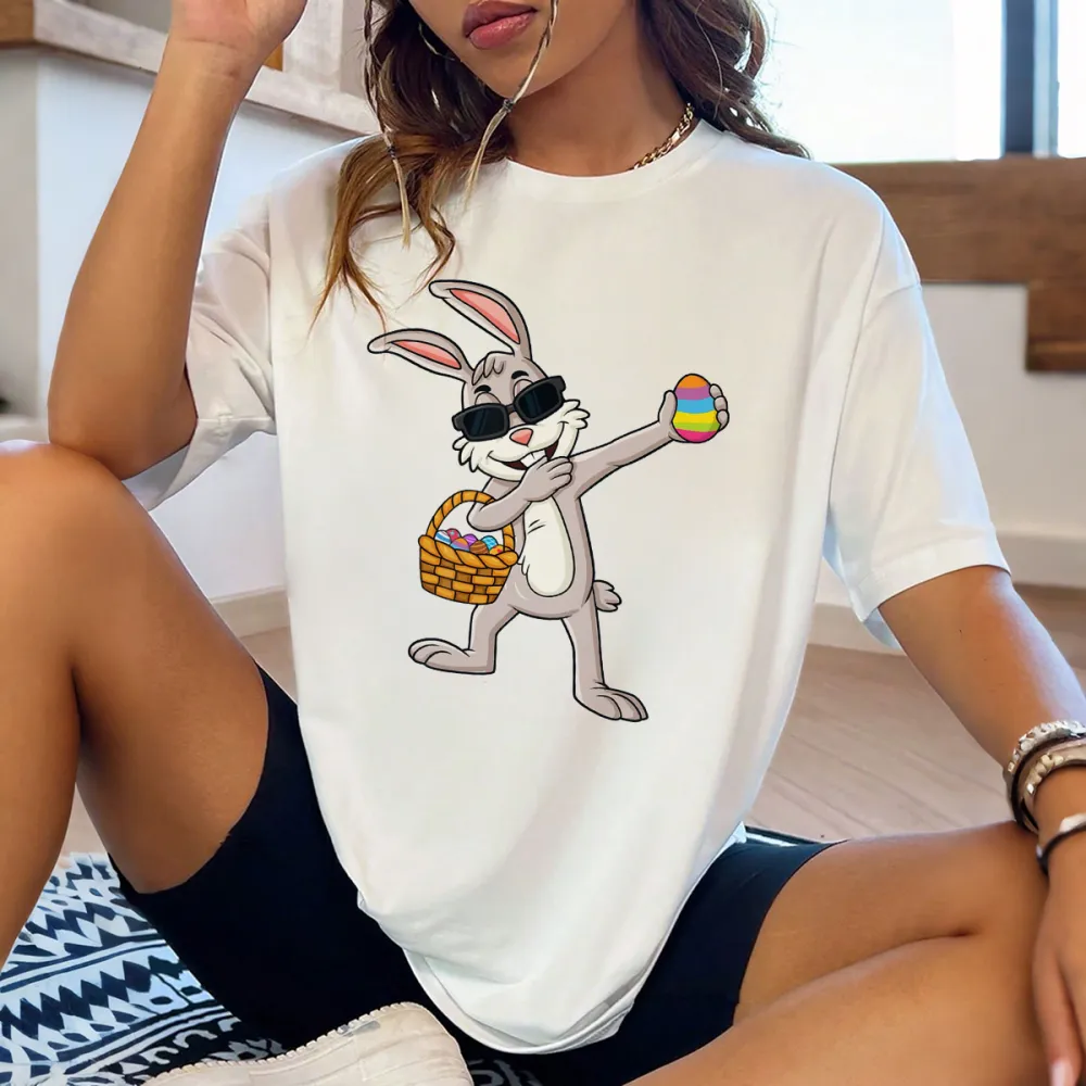 A Cartoon Rabbit Wearing Black Sunglasses, Holding A Colorful Easter Egg, With A Basket Full Of Eggs Next To The Other Hand. The Style Is Playful And Cute, With A Casual T-Shirt.