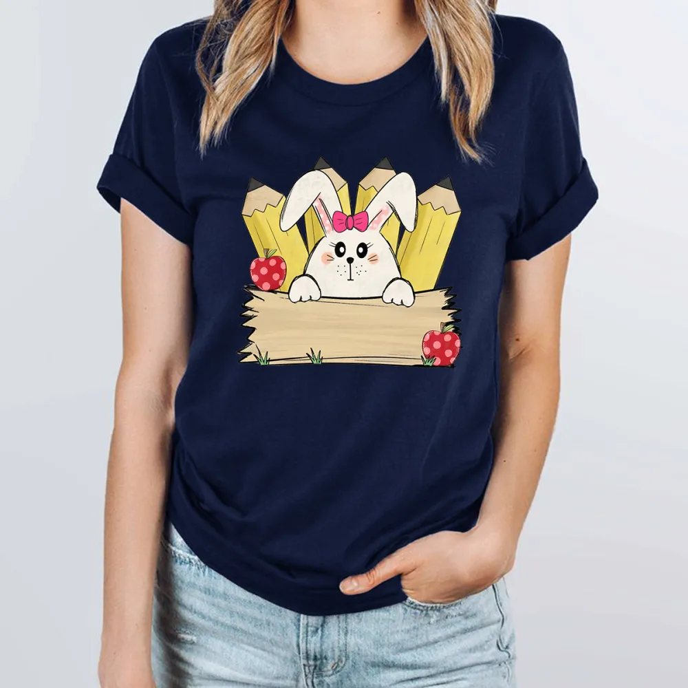 A Cartoon White Rabbit Wearing A Pink Bow Holding A Blank Board, A Yellow Pencil And A Red Strawberry With White Dots, A Childlike, Fresh Style, Casual T-Shirt