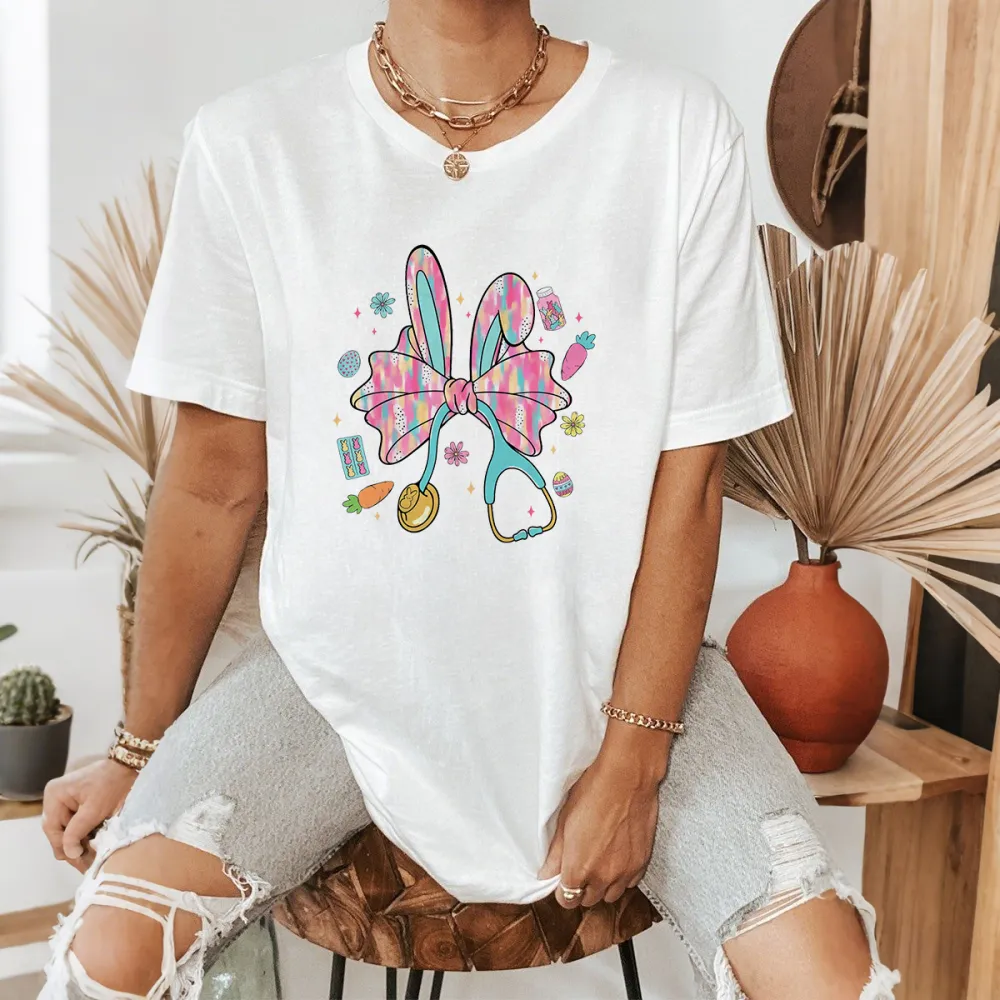 A Big Colorful Bow, Rabbit Ears, And Surrounded By Carrots, Easter Eggs, And Stethoscope Patterns. The Overall Style Is Lively And Casual T-Shirt.